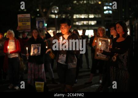 People take part in the candle lit vigil for Iranian nation Reza Barati at the Manus Island detention centre. Stock Photo