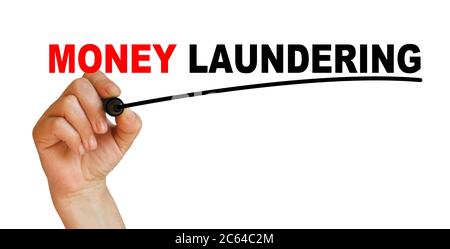Hand underlining money laundering with red marker Stock Photo