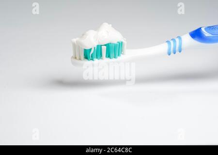 Toothbrush with toothpaste isolated on white background Stock Photo