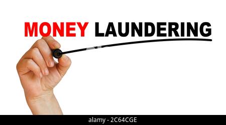 Hand underlining money laundering with red marker Stock Photo