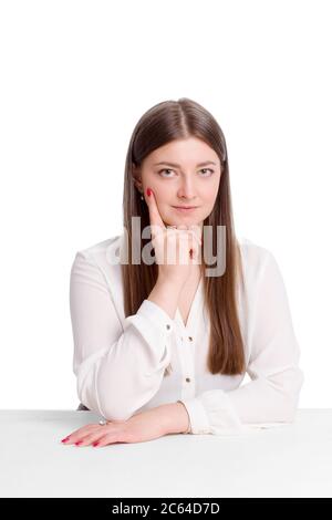 A young business woman a background isolated in white, in white shirts, sitting at the table, leaning his head on his hand Stock Photo