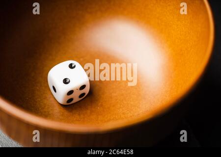 White dices in a wooden bowl Stock Photo