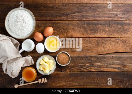 Baking ingredients and tools on rustic wooden background. Baking a cake, cookies or pastry. TOp view copy space Stock Photo