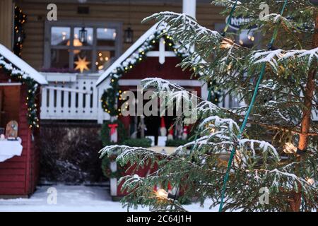 Christmas tree on the blured background of the Christmas market. Stock Photo