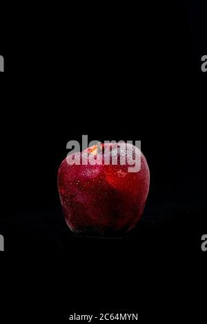 fresh and delicious red apple isolated against black background, with water droplets on the apple, selective focus Stock Photo
