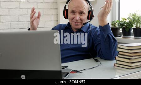 Man Working Remote from Home Using Laptop Connection Stock Photo