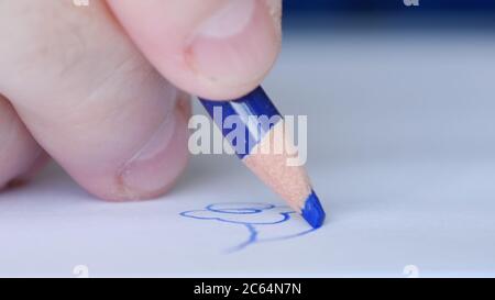 Image with a Person Drawing with a Colored Pencil on a White Piece of Paper a Flower Stock Photo