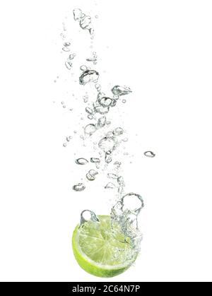 lime dropped in water isolated on white Stock Photo