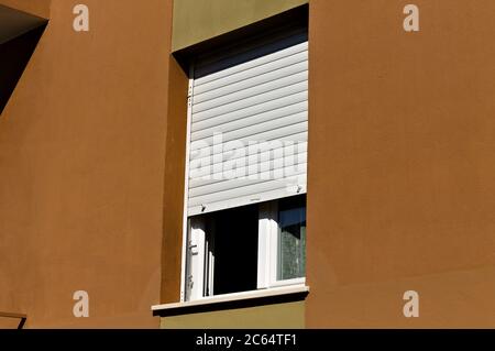 An isolated open window on a brown vintage house with a white shutter (Pesaro, Italy, Europe) Stock Photo