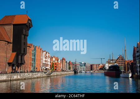 Gdansk, Poland - September 2015: Sunny views along the waterfront of Gdansk with the Zuraw (Giant Crane) and Maritime Museum against clear blue sky Stock Photo