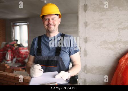 Male worker in protective helmet and coveralls Stock Photo