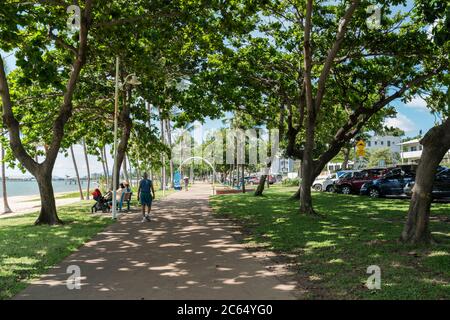 People walking for exercise on The Strand, Townsville, Australia, on a warm autumn day Stock Photo