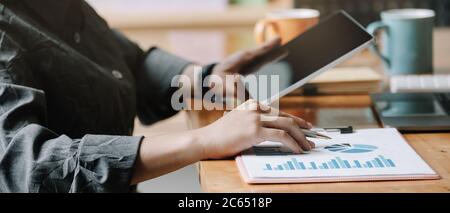 Business woman analysis financial report with tablet computer. Stock Photo