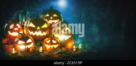 Halloween pumpkin head jack lantern with burning candles Stock Photo
