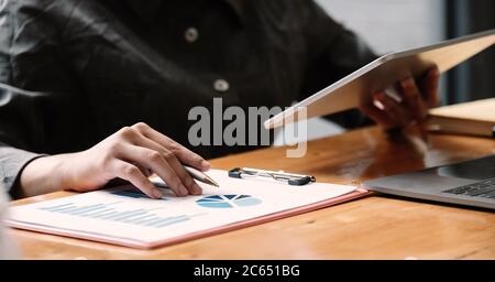 Business woman using tablet computer for analysis financial report Stock Photo