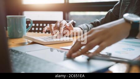 Woman use calculator for finance and accounting Analyze financial budget Stock Photo