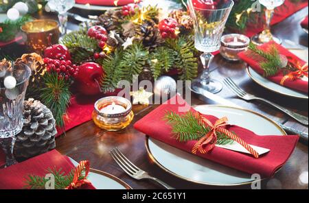 Christmas holidays table setting concept - wine glasses and tableware for festive dinner at home Stock Photo