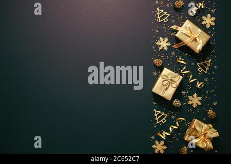Christmas golden decoration with gift boxes on dark background. Template for greeting card Stock Photo