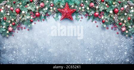 Christmas background with fir branches and holiday decoration on snowy board Stock Photo