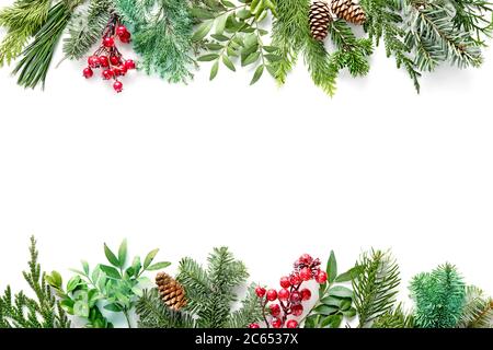 Flat lay composition with winter fir branches, cones, holly isolated on white background. Copy space for text Stock Photo