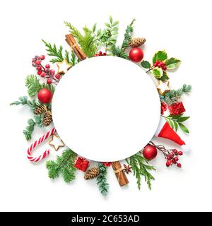 Flat lay composition with winter fir branches, cones, holly and Christmas decoration and blank card on white background. Copy space for text Stock Photo