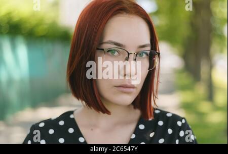 Portrait of beautiful redhead woman wearing glasses. Stock Photo