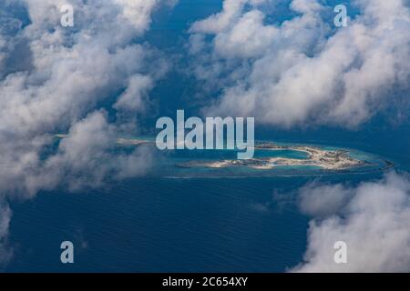 Aerial view of the Maldivian atolls the islands in the ocean with carols and the turquoise beautiful water Stock Photo