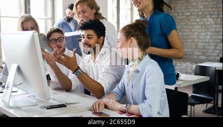 Group of young business people and designers. They working on new project. Startup concept Stock Photo