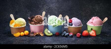 Various colorful ice cream in paper cup on dark rustic background Stock Photo