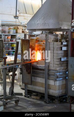 Glass Blowers Oven with the rods inside. The door is open showing the hot glow. Stock Photo
