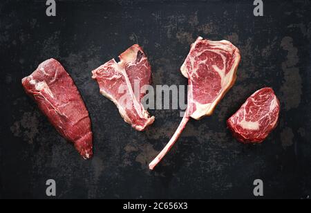 Variety of raw beef meat steaks for grilling with seasoning and ...