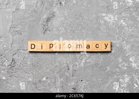 diplomacy word written on wood block. diplomacy text on cement table for your desing, concept. Stock Photo