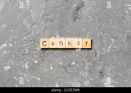 Censor word written on wood block. Censor text on cement table for your desing, concept. Stock Photo