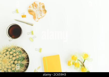 Resin art with diary, cup of tea, clips and narcissus on white background. Flat lay, top view Stock Photo