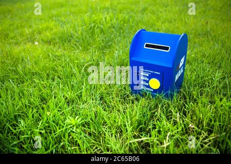 Blue mailbox on the grass Stock Photo