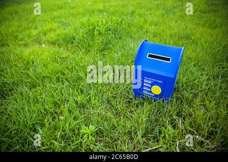 Blue mailbox on the grass Stock Photo