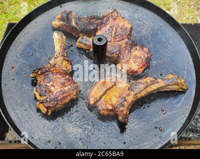 Three steaks are fried on pan. Summer season hot food Stock Photo