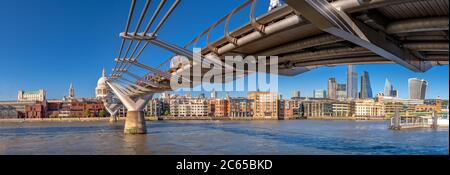 Panorama of the Thames river with Millennium bridge and Saint Paul's Cathedral and the City skyline in the background. Panoramic view cityscape Stock Photo