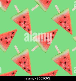 Colorful fruit Colorful fruit seamless pattern of fresh watermelon slices on a green background. The view from the top Stock Photo