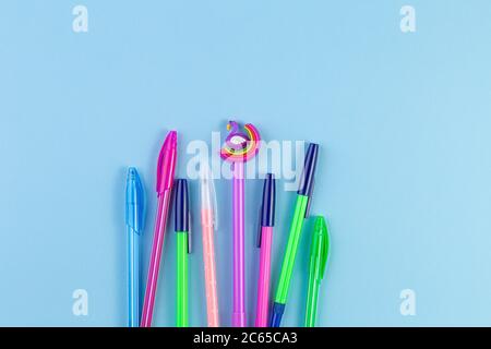 Set of colored pens on blue paper background with copy space. Flat lay, Top view. template for design. Stock Photo