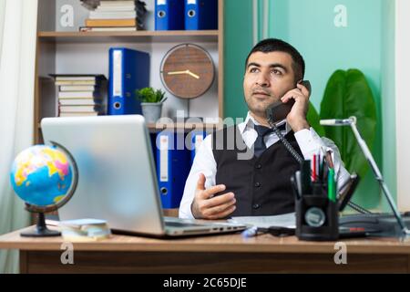 Young caucasian business man talking on the phone at office Stock Photo