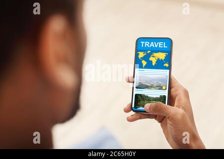 Unrecognizable black man reading travel blog on smartphone Stock Photo