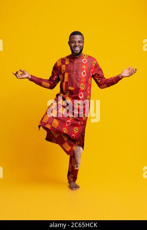 Happy african man standing on one leg, meditating Stock Photo