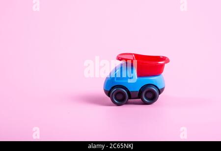 Red and blue 3D car on pink background Stock Photo