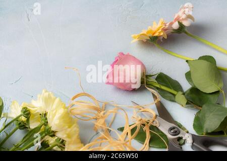 Cut Flowers on a Blue Rough Blue Plaster Background Stock Photo