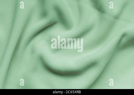 Light green fleece background texture, soft napped insulating fabric made of polyester, abstract wavy pattern, top view Stock Photo