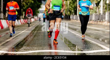 group runners athletes run on wet asphalt city marathon