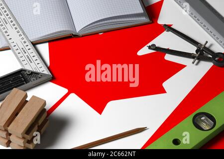 Canada national flag on profession concept with architect desk and tools background. Top view mock-up. Stock Photo