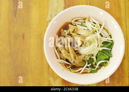 boiled thin rice noodles chicken leg and feet with bean sprout in herb brown soup on bowl Stock Photo