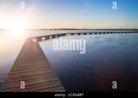 Wooden footbridge over a lake Stock Photo